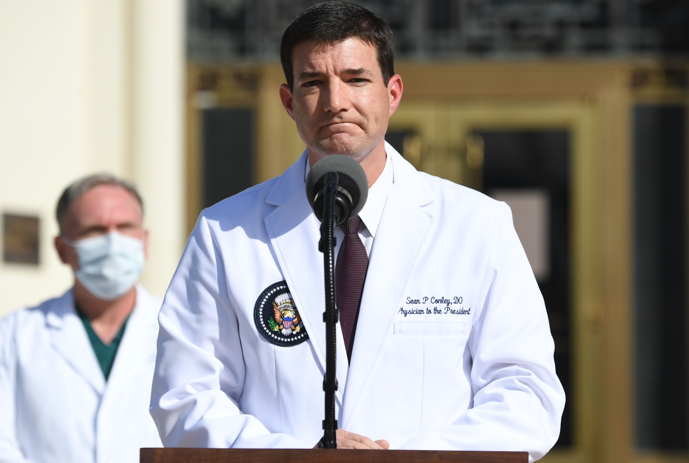 White House Doctor breaks silence on the new noticeable rotting rash-like mark on Trump's neck during an event in newly released photo, exposing the reason for the bruising on his hands, swollen ankles and rashes on his neck… it’s getting bad!