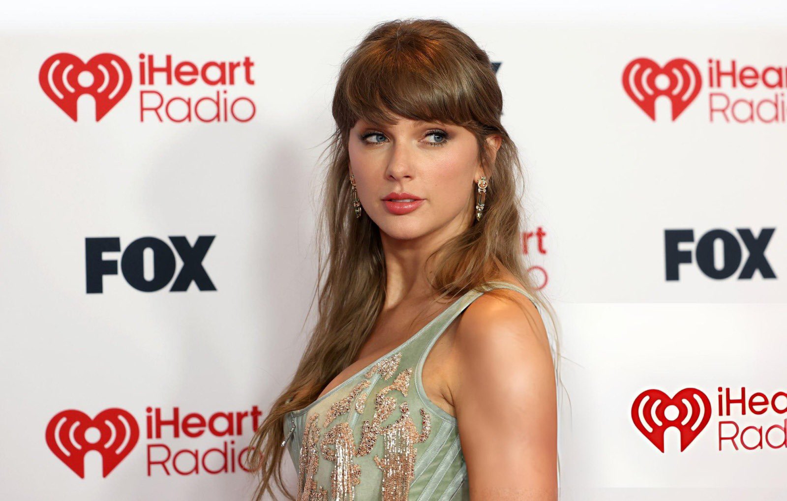 Taylor Swift makes a stunning picture-perfect appearance at the 2026 iHeartRadio Music Awards, but fans can't stop talking about one detail in her look... See more photos details